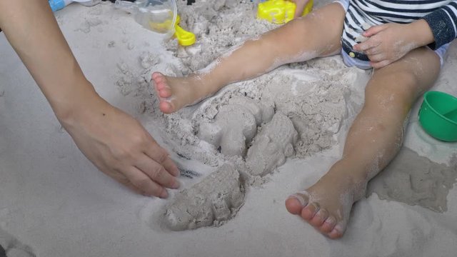 slow motion, mother playing sand with cute child have fun