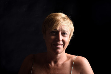 portrait of a middle aged woman on black