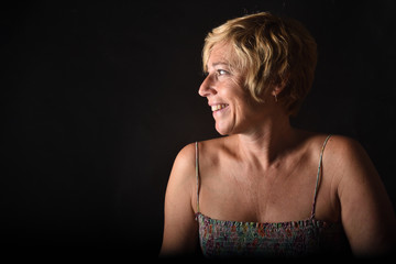 portrait of a middle aged woman on black