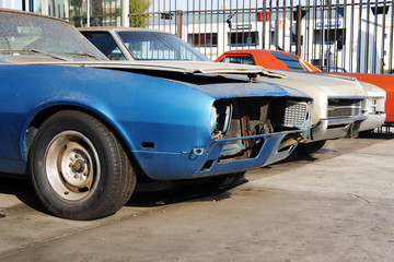 Fototapeta na wymiar A view of classic vintage damaged American car in a garage