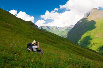 Naklejka premium A man in mountain day summer. Green forest