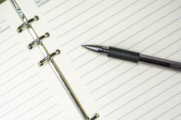 notebook and pen on white background