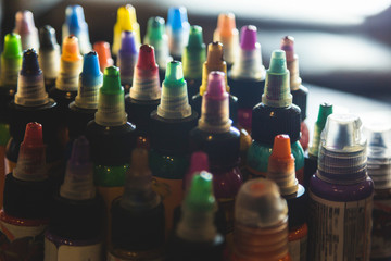 many professional bottles with colored ink for tattoos. tattoo parlor