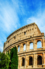 The ruins of the Colosseum are against the blue sky with white traces from the floating clouds. Rome. Italy.
