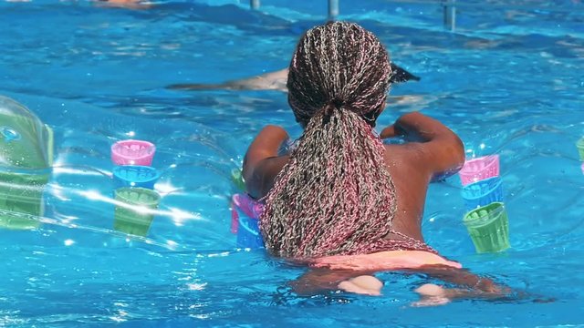 African American girl smiling in pool