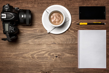 cup of coffee and notebook on wooden table