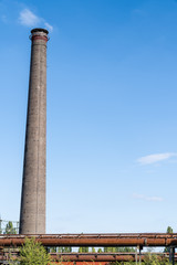 Factory chimney against a blue sky at the abandonned blast furnace at Duisburg Landschafts Park Germany
