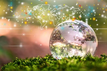 Female hands holding glass Globe on background