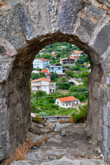 View of the city through the loophole. Old fortress, Bar, Montenegro
