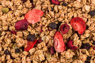Muesli oat cereals close up background with dry fruits