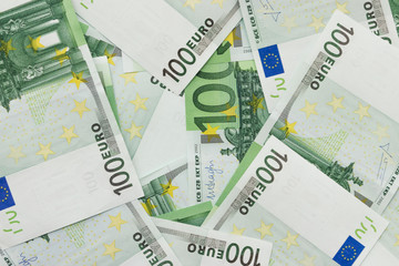 Background of banknotes in nominal value of one hundred euros. The concept of the screensaver on the desktop