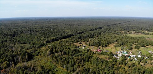 Fototapeta na wymiar Деревня в лесу с воздуха в солнечный день created by dji camera