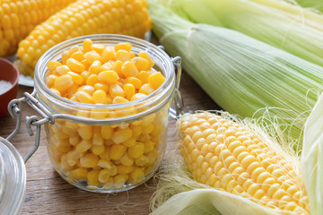 Canned sweet corn in glass jar, fresh and cooked corn on cobs.