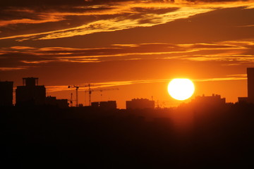 Cityscape with silhouette of city skyline against setting sun. Minsk, Belarus