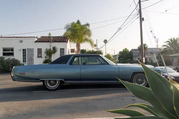 Zelfklevend Fotobehang Side view of a classic vintage American car in a parking lot in LA © CoolimagesCo