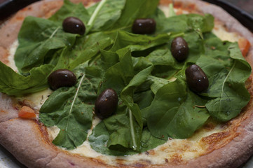 Homemade beet pizza with arugula and olivest
