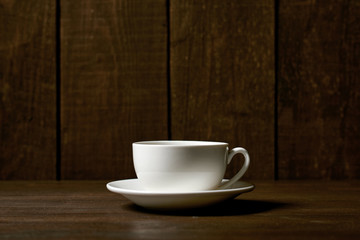 one classic coffee or tea cup on a dark wooden background