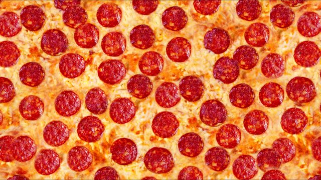 Single image of a pepperoni pizza on a white background. Background video.
 