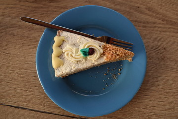 an appetizing slice of a pie made of banana and chocolate with a blue leaf on top and a cranberry on an emerald plate