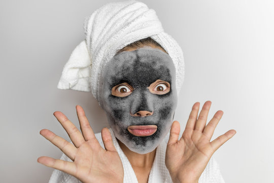 Face mask bubble foam funny woman at beauty spa looking or surprised, scary chemicals in beauty products. Asian girl wearing bath towel hair. Stock Photo | Adobe