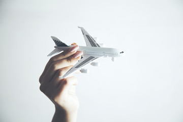 woman holding an airplane model in hand