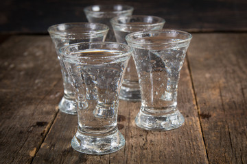 russian vodka in shot glasses on a dark wooden background