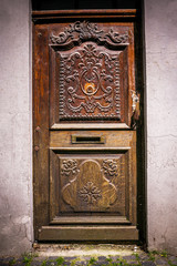 antique oak wood door in stone wall