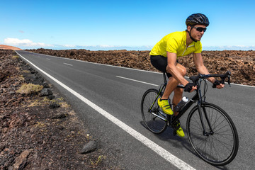 Road bike cyclist man biking riding racing bicycle training for triathlon race. Sports athlete...