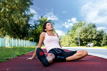 Fototapeta na wymiar Young woman resting after jogging