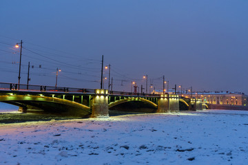 Fototapeta premium Exchange Bridge over frozen Malaya Neva River at night. Saint Petersburg. Russia