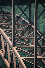 Detail of the metal arch of the bridge over the New River Gorge in Fayetteville, West Virginia.  The bridge is the longest steel span in the western hemisphere.  Repeating lines.  Vertical image.