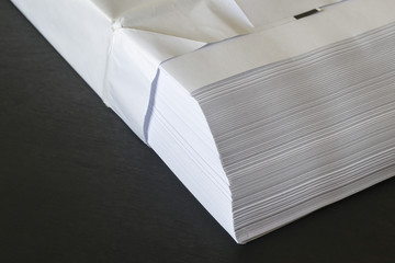 Pile of paper on a black background.