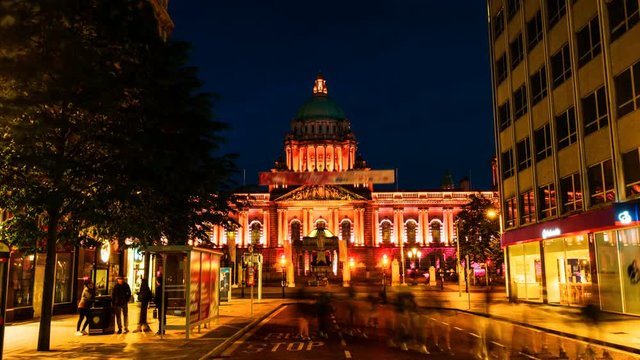 Belfast, UK. Nightlife with city hall in Belfast, UK the capital of Northern Ireland. Time-lapse of car traffic ar night with dark blue sky. Zoom in