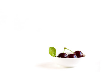 Fototapeta premium ripe cherries on a white background