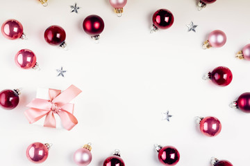 Naklejka na ściany i meble Christmas flat lay frame with pink abd violet glass balls and gift box, retro toned