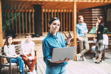 Woman with glasses and a laptop. Modern employee of the creative team.