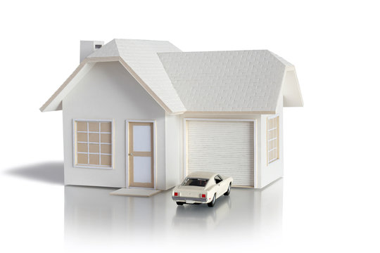 House miniature with car isolated in white background for real estate and construction concepts. House miniature designed and created by contributor