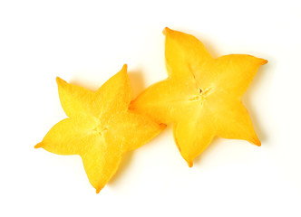 Fototapeta premium Top View of Vibrant Yellow Star Shape of Two Sliced Ripe Star Fruits on white background 