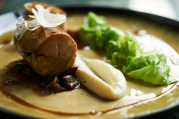 Goose galantine, mushroom fricassee, young cabbage and sauce. chicken sausage with baked green cabbage. Healthy diet food concept.