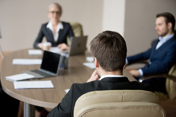 Business people meeting in office. Close up of man boss leader team sitting his back to camera,...