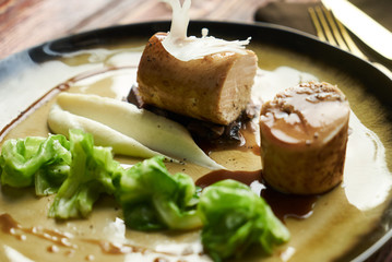 Goose galantine, mushroom fricassee, young cabbage and sauce. chicken sausage with baked green cabbage. Healthy diet food concept.