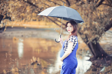 Young girl in autumn park