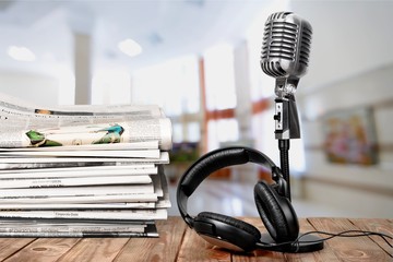 News and microphone on table.