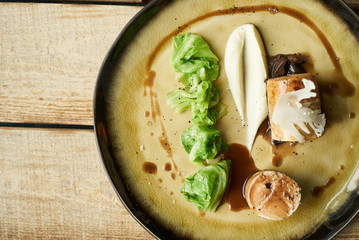 Duck galantine, mushroom fricassee, young cabbage and sauce. chicken sausage with baked green cabbage. Healthy diet food concept.