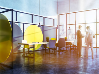 Businessmen talking in geometric pattern boardroom