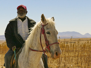 Old Basotho man on horse In the African Kingdom of Lesotho - obrazy, fototapety, plakaty