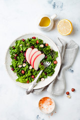 Kale salad with dried cranberry, hazelnuts and sliced apple
