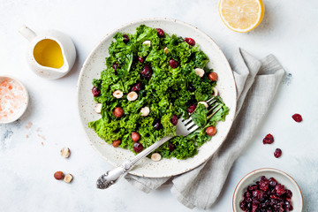 Kale salad with dried cranberry, hazelnuts and olive oil