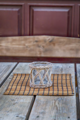 Handmade candlestick on a old wooden table. Vintage style