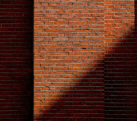 View at brick wall with shadow. Real hosue brick wall